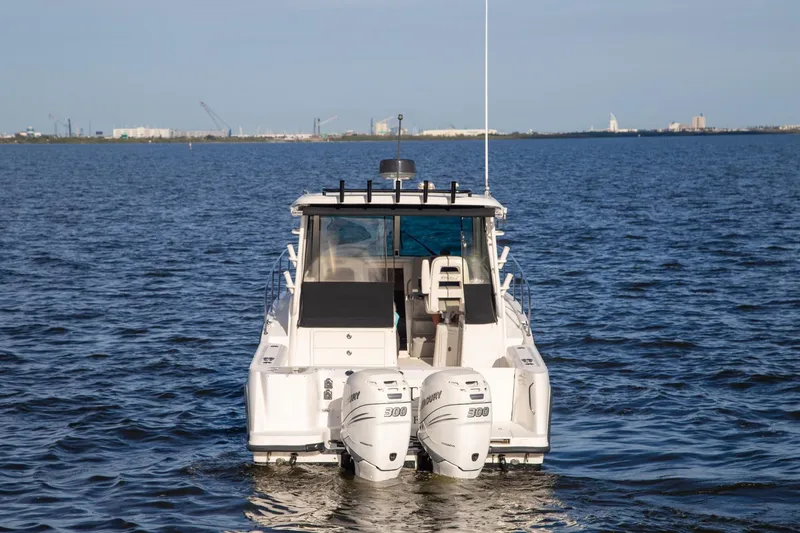 Slide: The Image of 2014 Boston Whaler 315 Conquest boat on open water, rear view. - 3