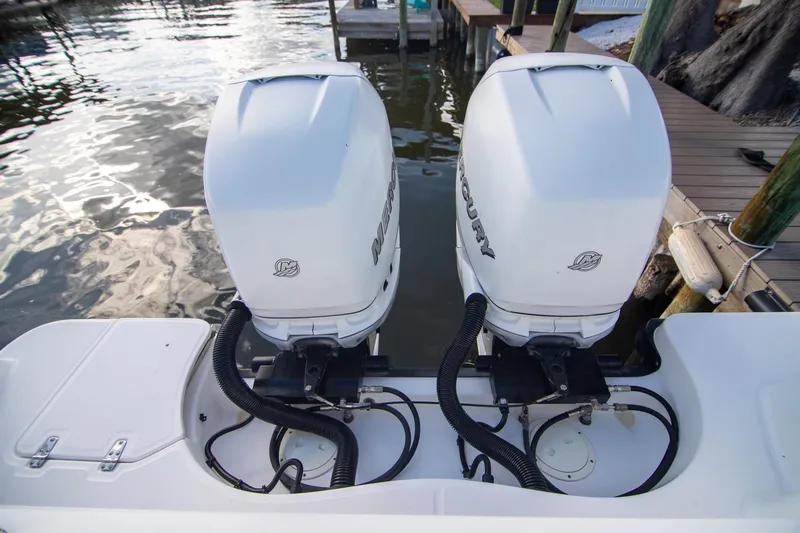 Slide: The Image of Twin Mercury outboard engines on a 2014 Boston Whaler 315 Conquest boat. - 36