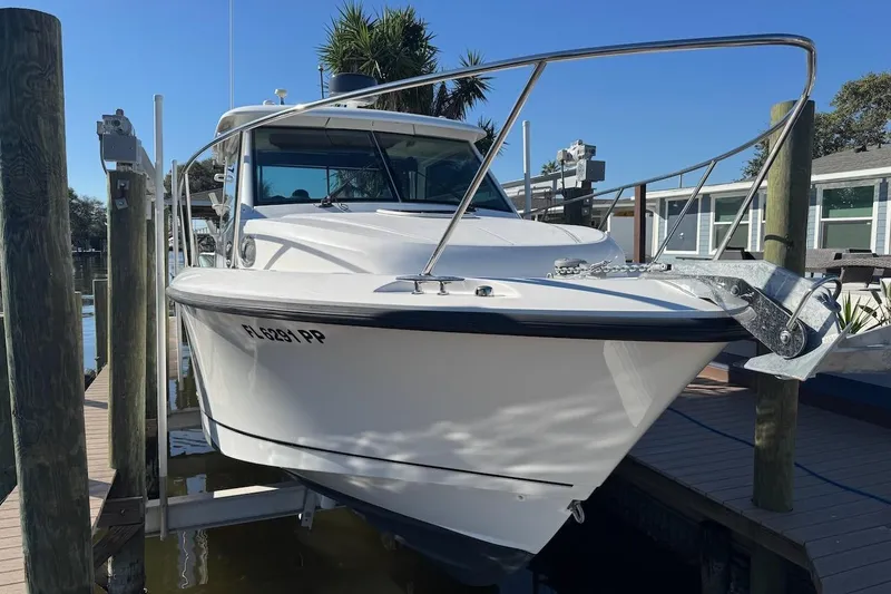 Slide: The Image of 2014 Boston Whaler 315 Conquest boat docked at marina, front view. - 4