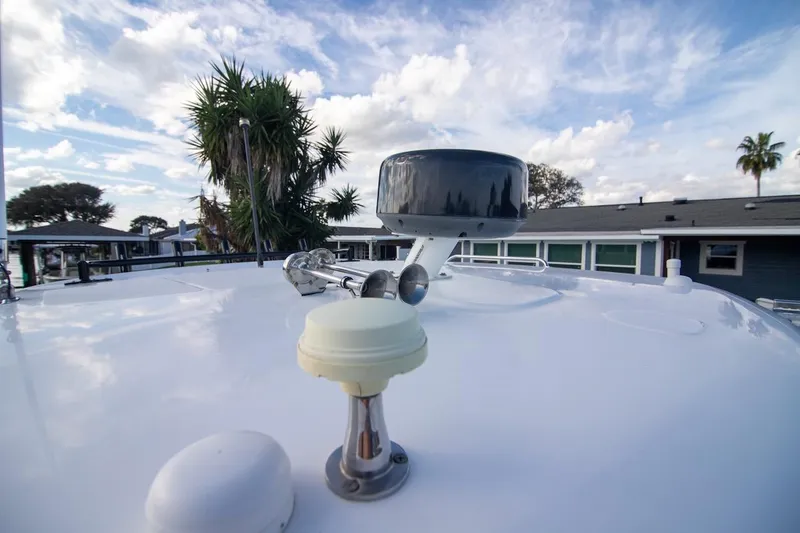 Slide: The Image of 2014 Boston Whaler 315 Conquest boat deck with radar and clear sky. - 40