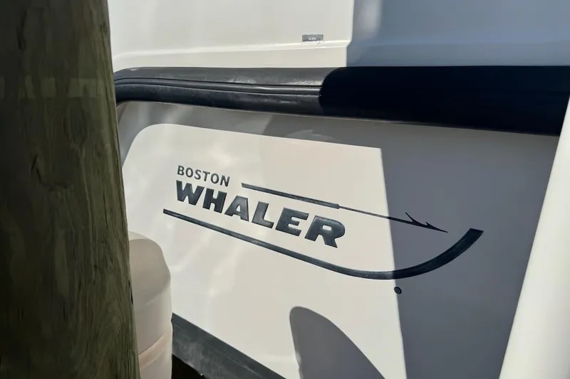 Slide: The Image of 2014 Boston Whaler 315 Conquest boat logo on hull. - 43