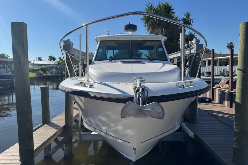 Slide: The Image of 2014 Boston Whaler 315 Conquest docked, front view with anchor, sunny day. - 5