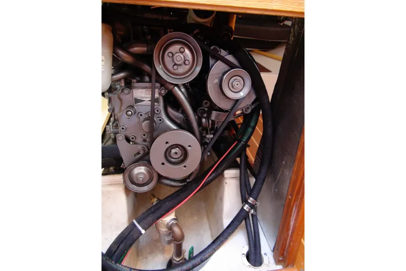 Slide: The Image of Engine compartment of a 2003 Hunter 306 sailboat, showing belts and hoses. - 12