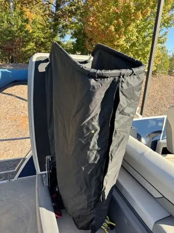 Slide: The Image of 2022 Godfrey Pontoons Monaco 235 with black cover, outdoor setting. - 4