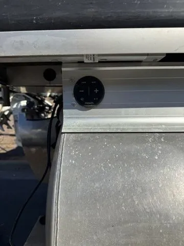 Slide: The Image of 2022 Godfrey Pontoons Monaco 235 control panel detail, featuring a sleek metallic finish. - 9