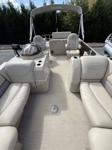 Slide: The Image of 2017 Sylvan 8524 DLZ LE pontoon boat with beige seating and spacious deck. - 9