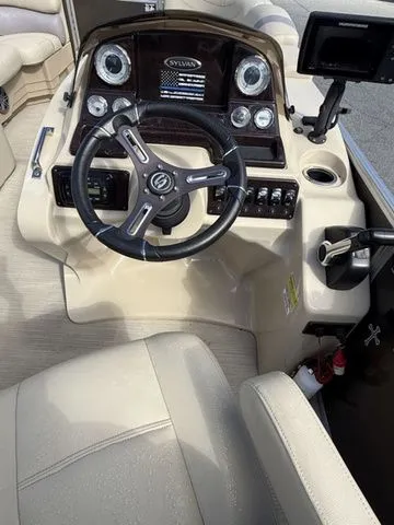 Slide: The Image of 2017 Sylvan 8524 DLZ LE boat dashboard with steering wheel and controls. - 7