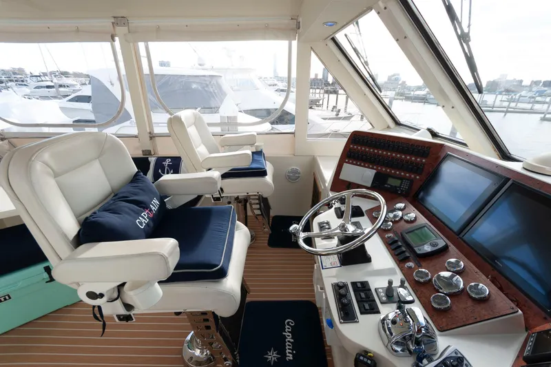 Slide: The Image of Luxurious helm of 2007 Novatec 55 Islander CPMY yacht with captain's chairs and navigation controls. - 10