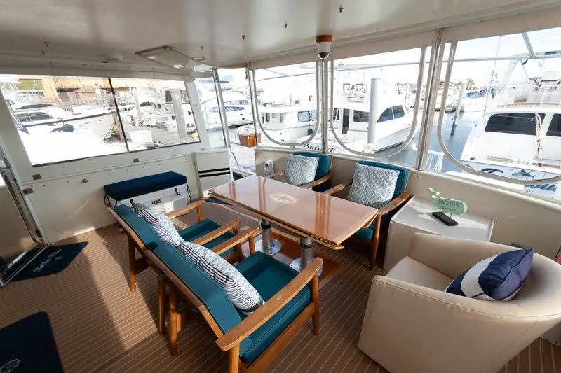 Slide: The Image of Luxurious 2007 Novatec 55 Islander CPMY yacht interior with elegant seating and marina view. - 16