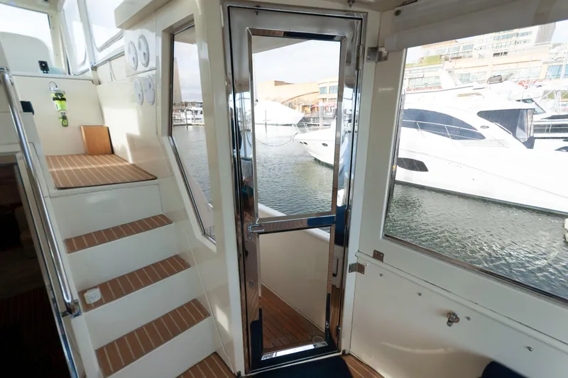 Slide: The Image of Interior view of 2007 Novatec 55 Islander CPMY yacht with stairs and marina backdrop. - 19