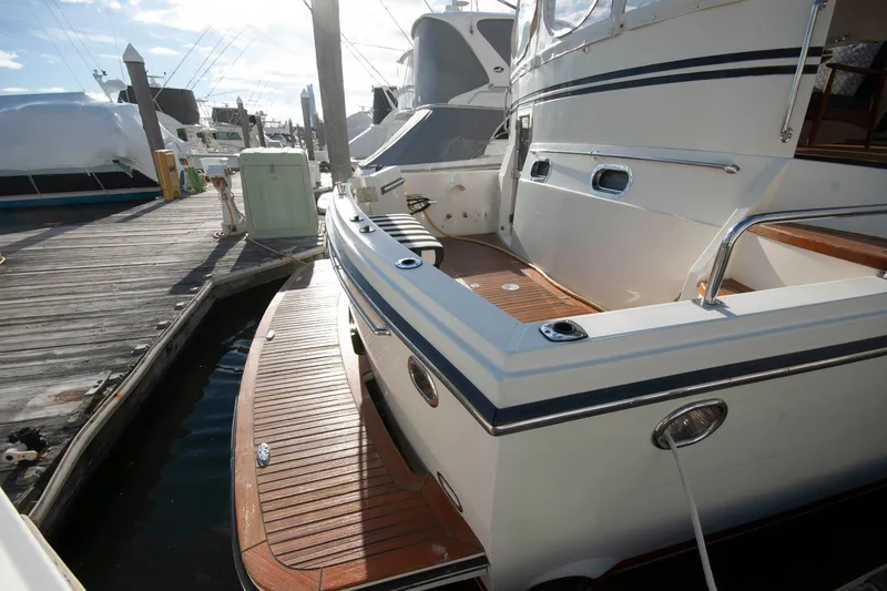 Slide: The Image of 2007 Novatec 55 Islander CPMY yacht docked at marina, showcasing elegant deck design. - 5