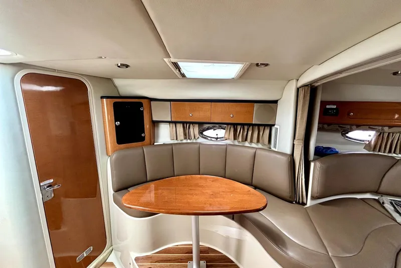 Slide: The Image of 2008 Chaparral Signature 330 interior with cozy seating and wooden table. - 15