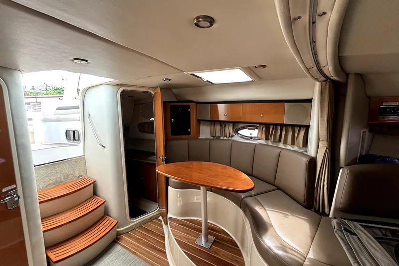 Slide: The Image of 2008 Chaparral Signature 330 interior with curved seating, wooden table, and modern design. - 16