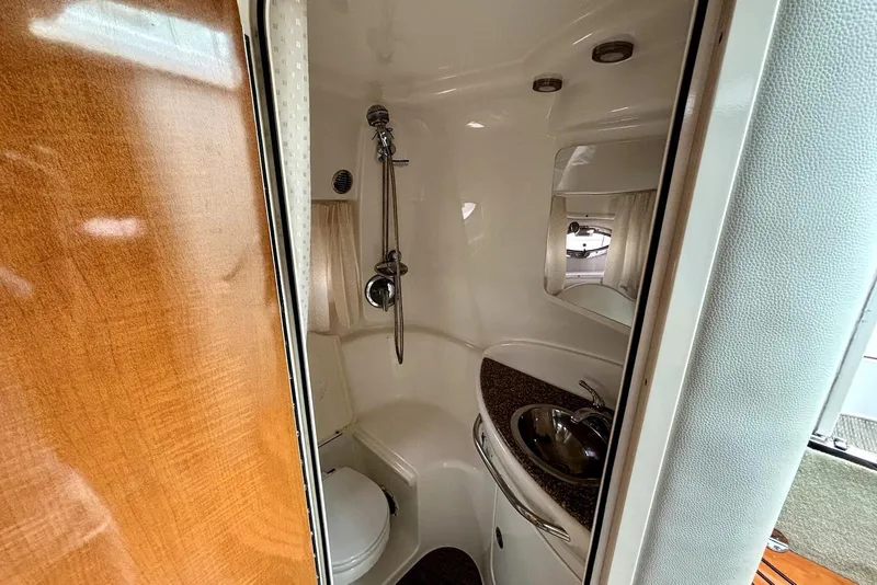 Slide: The Image of 2008 Chaparral Signature 330 bathroom with shower, sink, and toilet in compact design. - 18