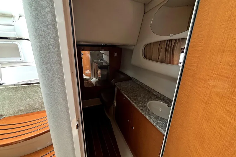 Slide: The Image of 2008 Chaparral Signature 330 interior with wood cabinetry and compact bathroom. - 19