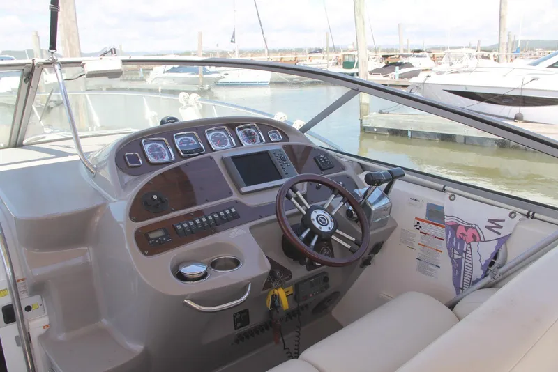 Slide: The Image of 2008 Chaparral Signature 330 boat dashboard with steering wheel and control panel. - 8