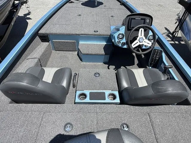 Slide: The Image of 2021 Vexus AVX1880 boat interior with dual seats, steering console, and carpeted flooring. - 4
