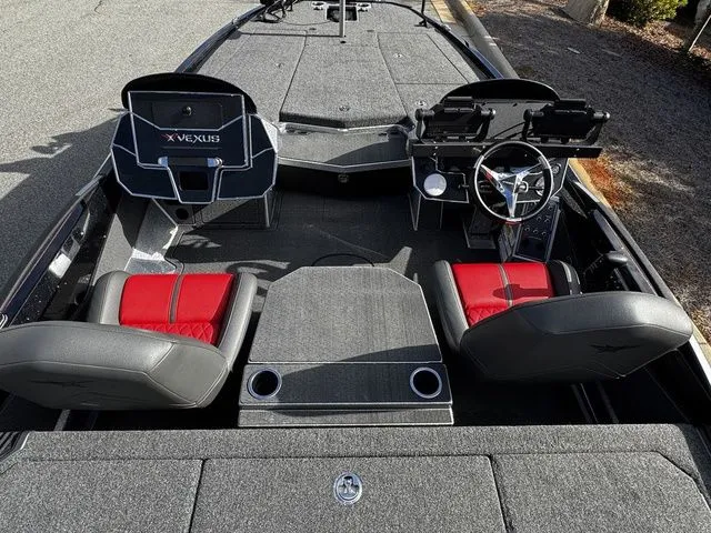 Slide: The Image of 2024 Vexus VXS20 boat interior with red and black seating, steering wheel, and control panels. - 5