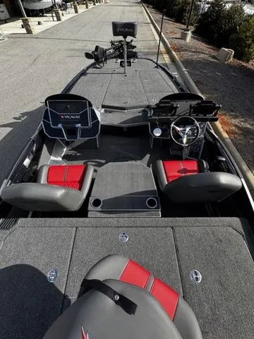 Slide: The Image of 2024 Vexus VXS20 boat interior with red and gray seating, steering wheel, and control panels. - 4