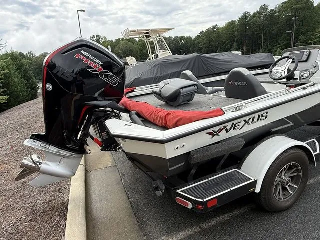 Slide: The Image of 2022 Vexus AVX1880 boat with Mercury Pro XS engine, parked on a trailer. - 3