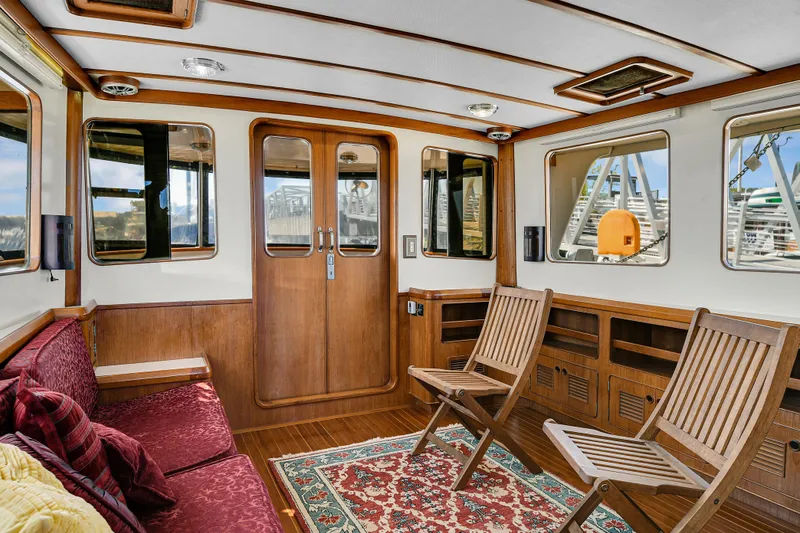 Slide: The Image of Interior of 1991 TransWorld Fantail 50 Motor Yacht with wooden decor and seating. - 10