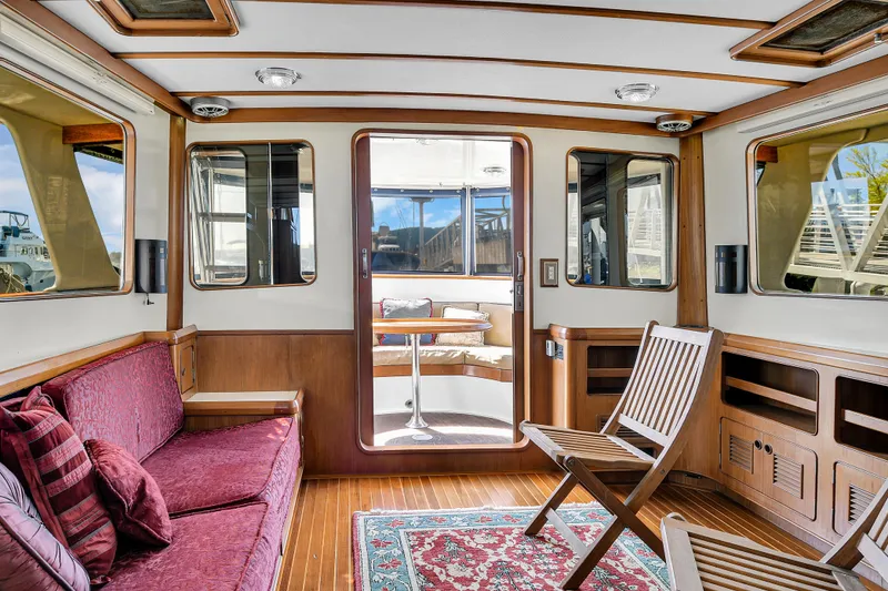 Slide: The Image of Interior of 1991 TransWorld Fantail 50 Motor Yacht with wooden accents and plush seating. - 11