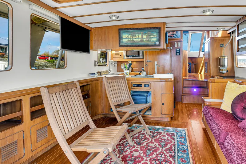 Slide: The Image of Luxurious 1991 TransWorld Fantail 50 Motor Yacht interior with wooden decor and comfortable seating. - 13