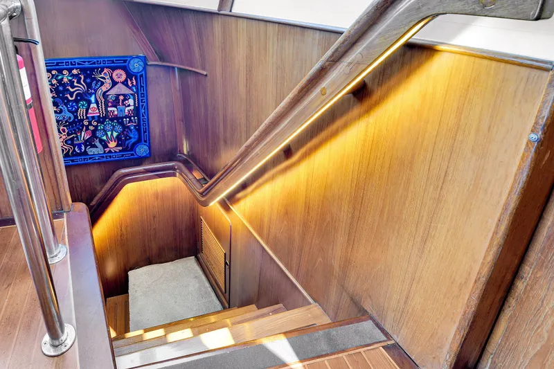 Slide: The Image of Staircase with wooden paneling and artwork on a 1991 TransWorld Fantail 50 Motor Yacht. - 16