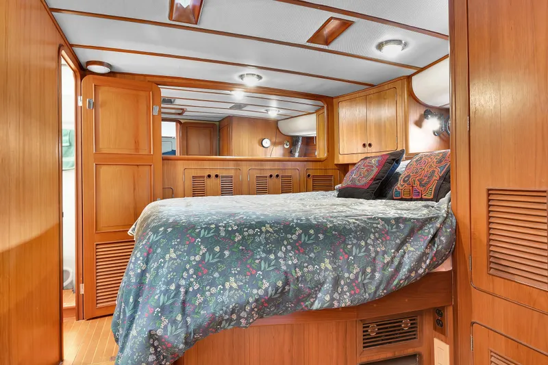 Slide: The Image of Luxurious bedroom interior of 1991 TransWorld Fantail 50 Motor Yacht with wood paneling. - 17