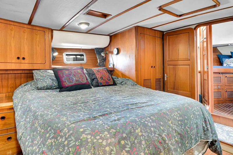 Slide: The Image of Luxurious bedroom interior of 1991 TransWorld Fantail 50 Motor Yacht with wood paneling. - 18