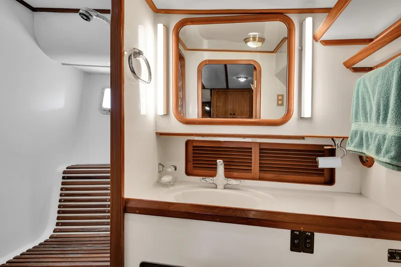 Slide: The Image of Luxurious bathroom interior of 1991 TransWorld Fantail 50 Motor Yacht with wooden accents. - 19