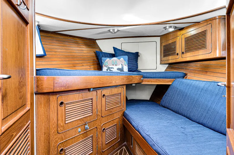 Slide: The Image of Interior of 1991 TransWorld Fantail 50 Motor Yacht with wooden cabinetry and blue seating. - 20