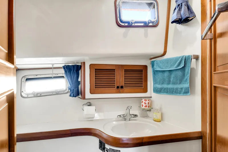 Slide: The Image of Bathroom interior of 1991 TransWorld Fantail 50 Motor Yacht with sink and wooden cabinetry. - 21