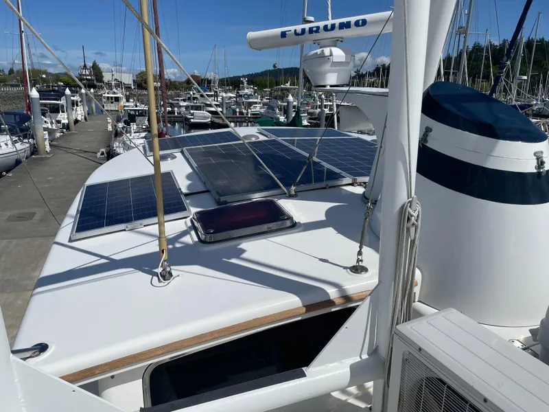 Slide: The Image of TransWorld Fantail 50 Motor Yacht 1991 with solar panels docked at marina. - 23