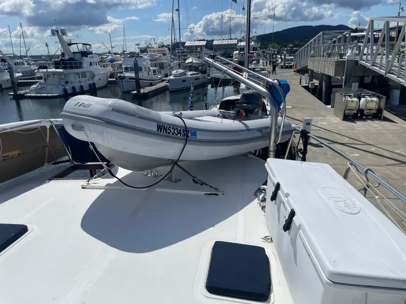 Slide: The Image of 1991 TransWorld Fantail 50 Motor Yacht with dinghy on deck at marina. - 24