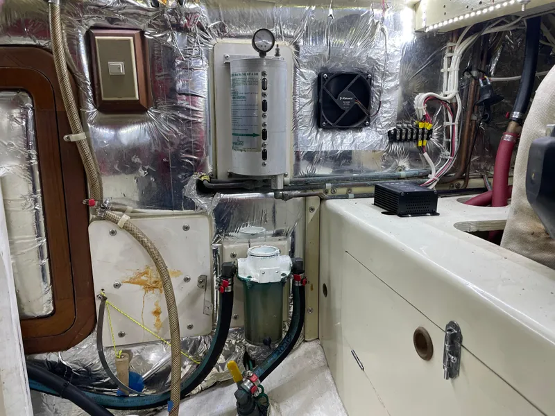Slide: The Image of Engine room of 1991 TransWorld Fantail 50 Motor Yacht with various mechanical components. - 28