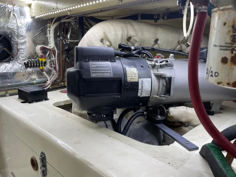 Slide: The Image of Engine room of 1991 TransWorld Fantail 50 Motor Yacht, showcasing mechanical components and wiring. - 29