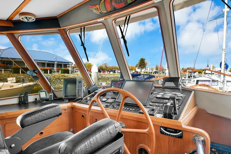 Slide: The Image of 1991 TransWorld Fantail 50 Motor Yacht helm with navigation equipment and marina view. - 3