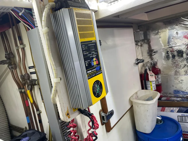Slide: The Image of Engine room of 1991 TransWorld Fantail 50 Motor Yacht with battery charger and fire extinguisher. - 34