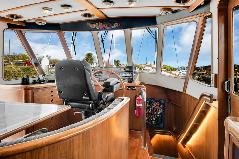 Slide: The Image of 1991 TransWorld Fantail 50 Motor Yacht helm with panoramic windows and wooden interior. - 4