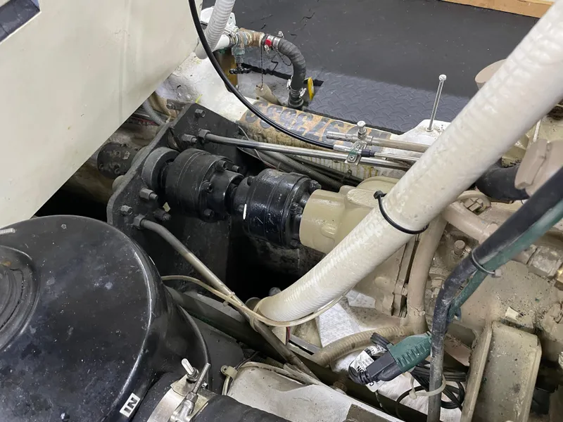 Slide: The Image of Engine compartment of 1991 TransWorld Fantail 50 Motor Yacht, showcasing mechanical components and hoses. - 40