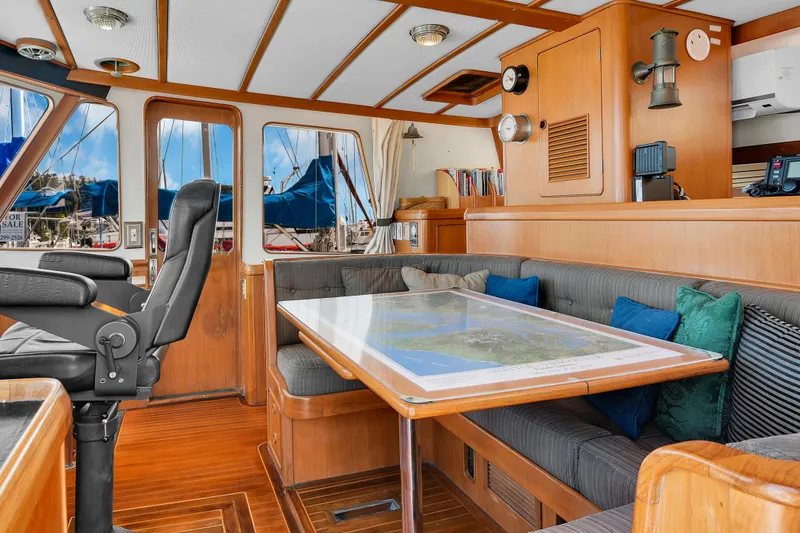 Slide: The Image of Interior of 1991 TransWorld Fantail 50 Motor Yacht with wooden furnishings and seating area. - 6