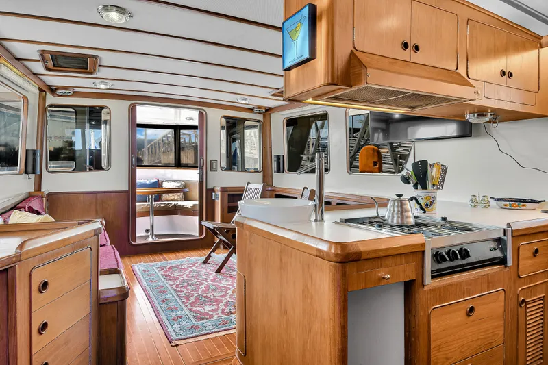 Slide: The Image of Interior of 1991 TransWorld Fantail 50 Motor Yacht with wooden cabinetry and modern kitchen. - 8
