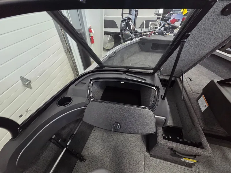 Slide: The Image of Interior view of 2026 Crestliner 1650 Hawk boat with storage compartment. - 13