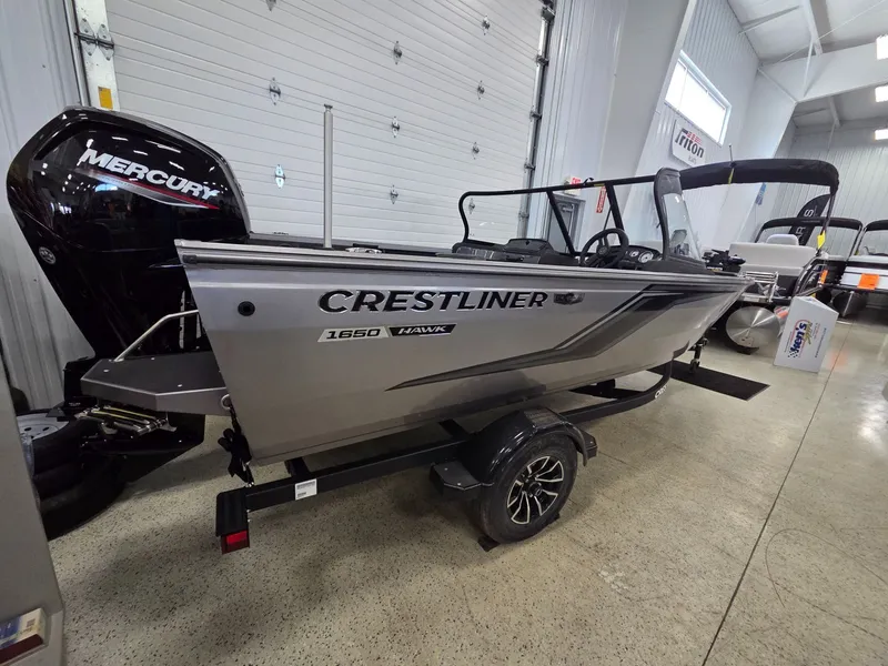 Slide: The Image of 2026 Crestliner 1650 Hawk boat displayed in showroom. - 3