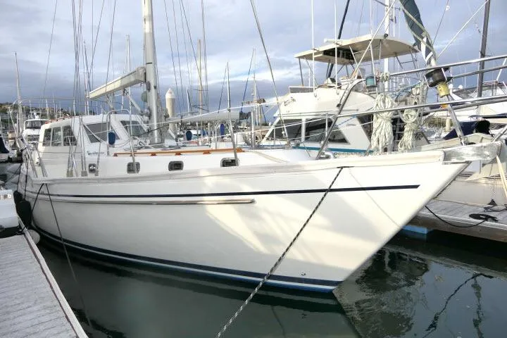 The Image of 2002 Tayana 460 Vancouver Pilothouse yacht docked at marina, side view. - 1