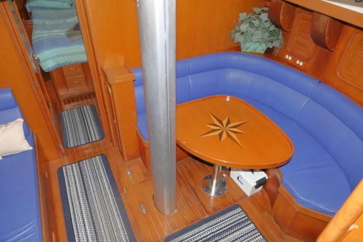 Slide: The Image of Interior of 2002 Tayana 460 Vancouver Pilothouse with blue seating and wooden table. - 10