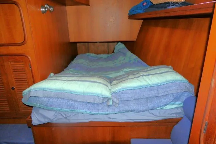 Slide: The Image of Cozy cabin bed in 2002 Tayana 460 Vancouver Pilothouse yacht with wooden interior. - 24