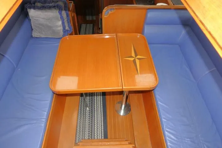 Slide: The Image of 2002 Tayana 460 Vancouver Pilothouse interior with blue seating and wooden table. - 3