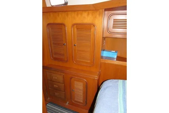 Slide: The Image of 2002 Tayana 460 Vancouver Pilothouse interior with wooden cabinets and drawers. - 38
